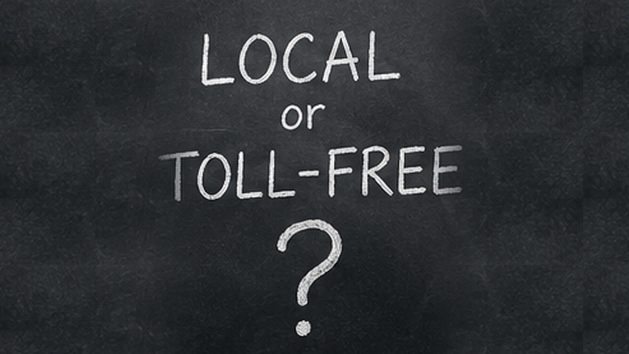 Chalkboard with the handwritten question Local or Toll-Free