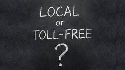 Chalkboard with the handwritten question Local or Toll-Free