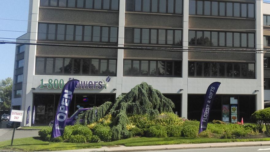 1-800 Flowers sign on the company's headquarters storefront